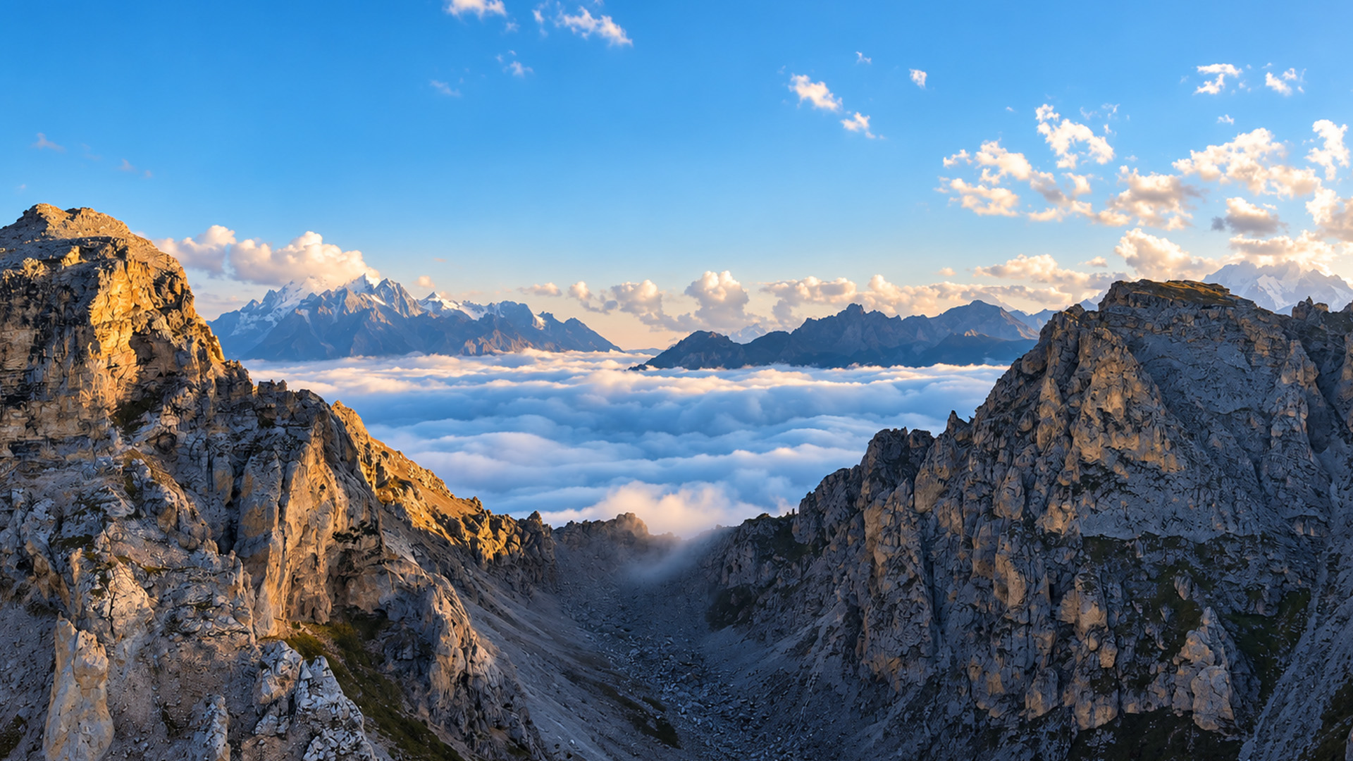 A sea of clouds between giant rocky mountains
