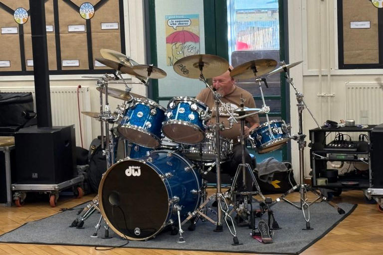 Status Quo drummer Jeff Rich gives pupils at Tyneside primary school a ...