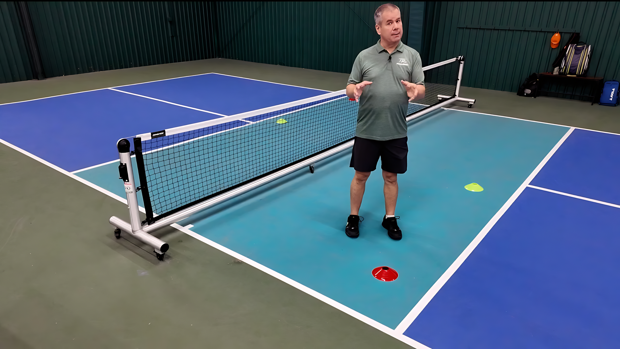 A pickleball dinking drill that uses green and red cone targets