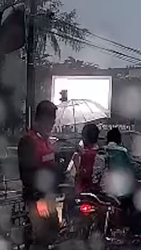Truck driver gives umbrella to young boy in heavy rain
