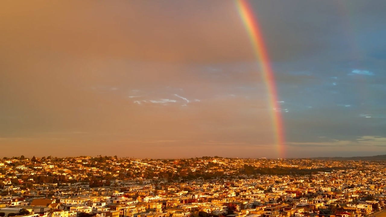 Double rainbow appears above Manhattan Beach during sunset