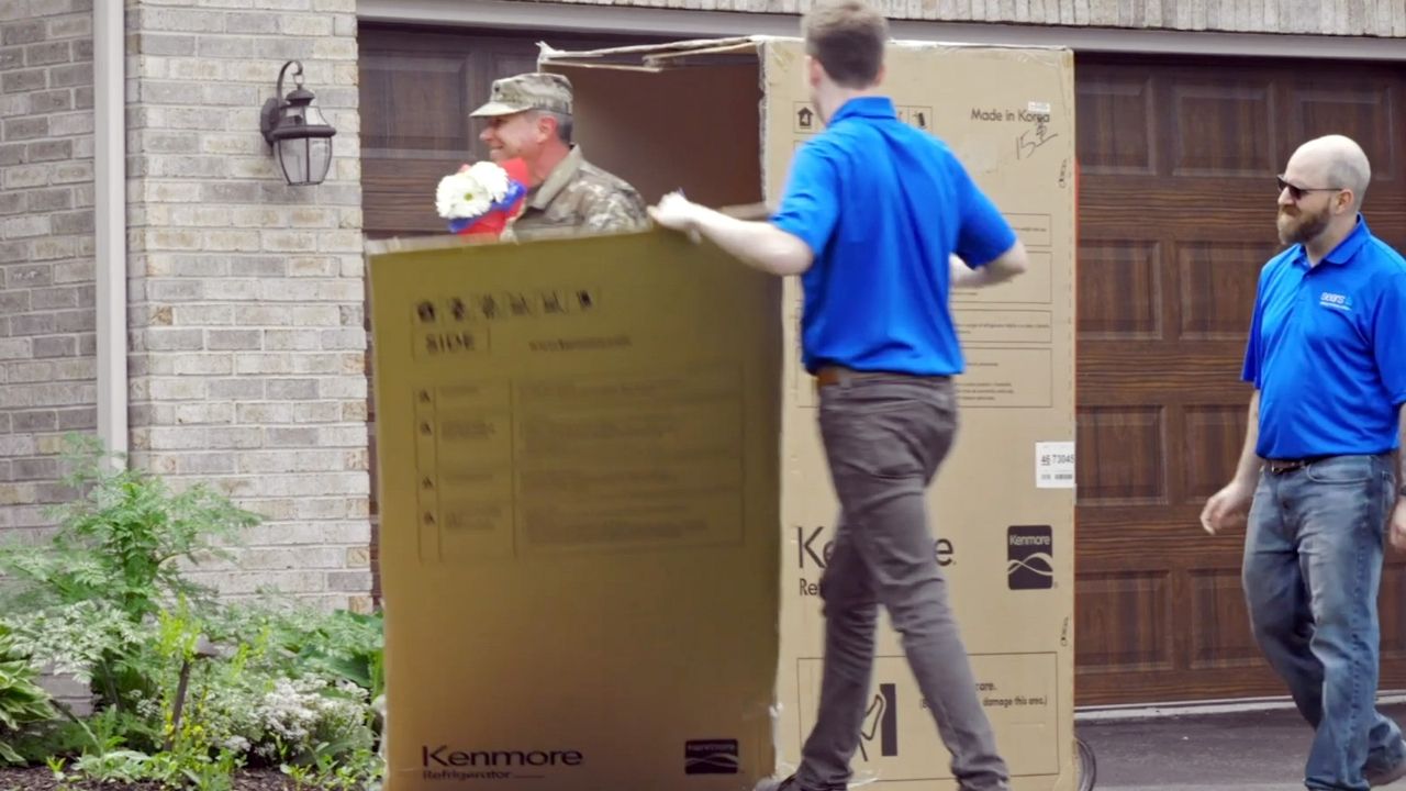 Military husband surprises wife by bursting from Sears delivery box ...