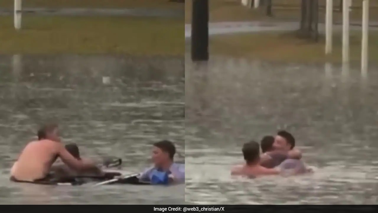 Australian reporter and bystander jump into floodwaters to rescue man ...