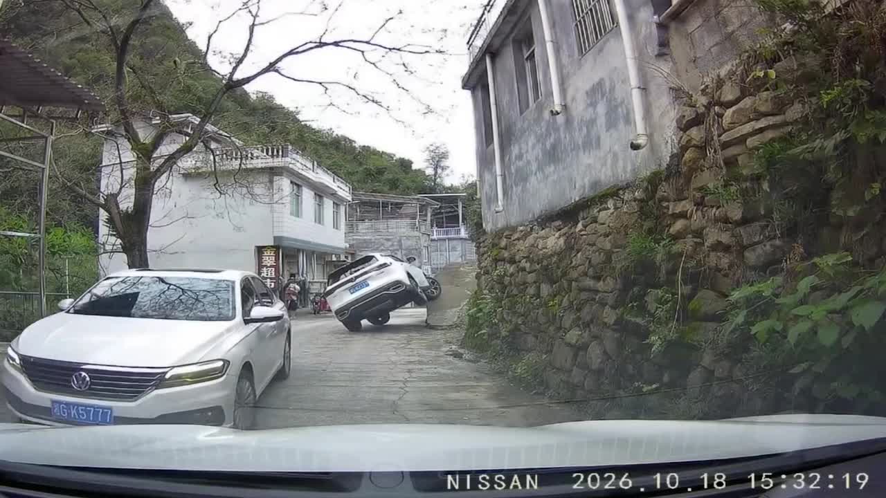 Car tips onto its side after driver attempts to escape roadside ramp