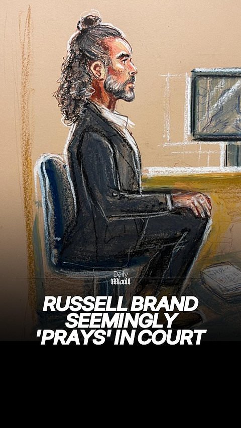 Russell Brand seemingly prays in court