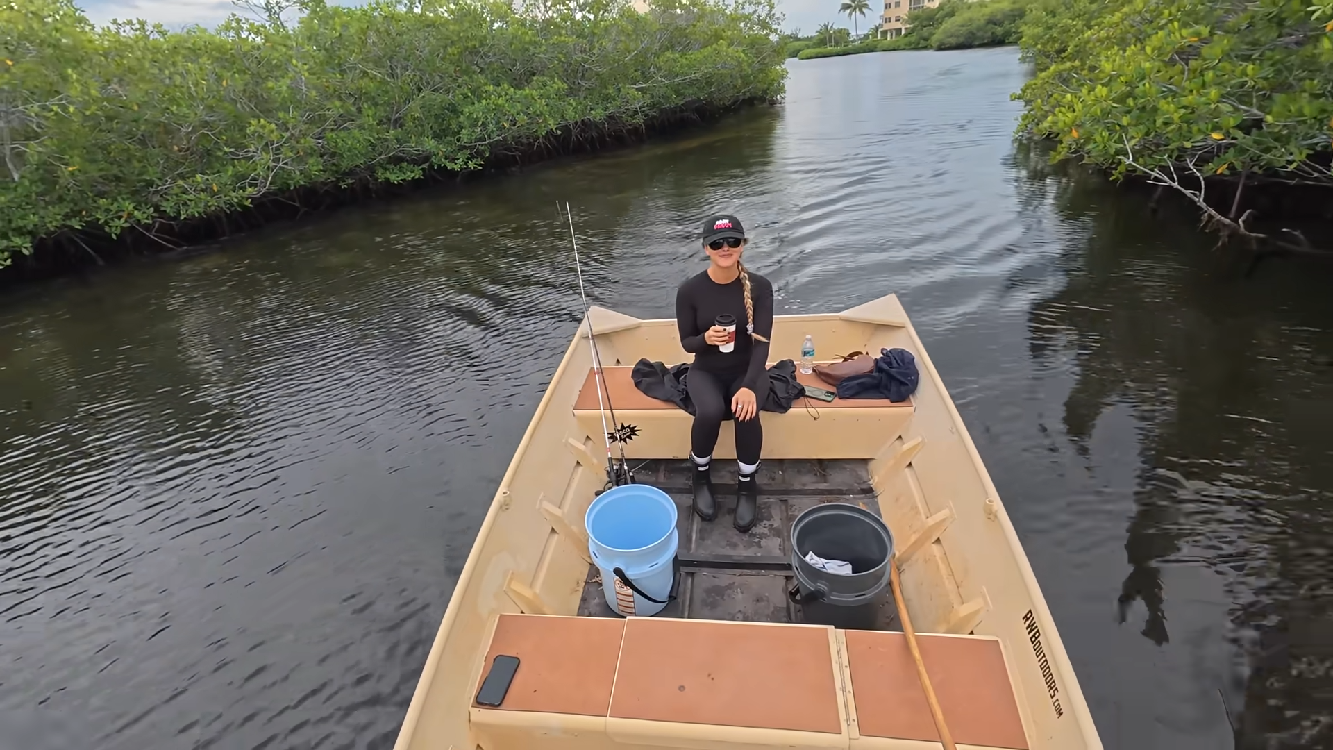 An angler takes a jon boat deep into the mangroves to fish