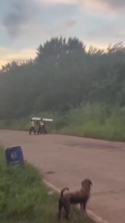 Delivery rider carries four-foot mattress on motorbike to deliver to ...