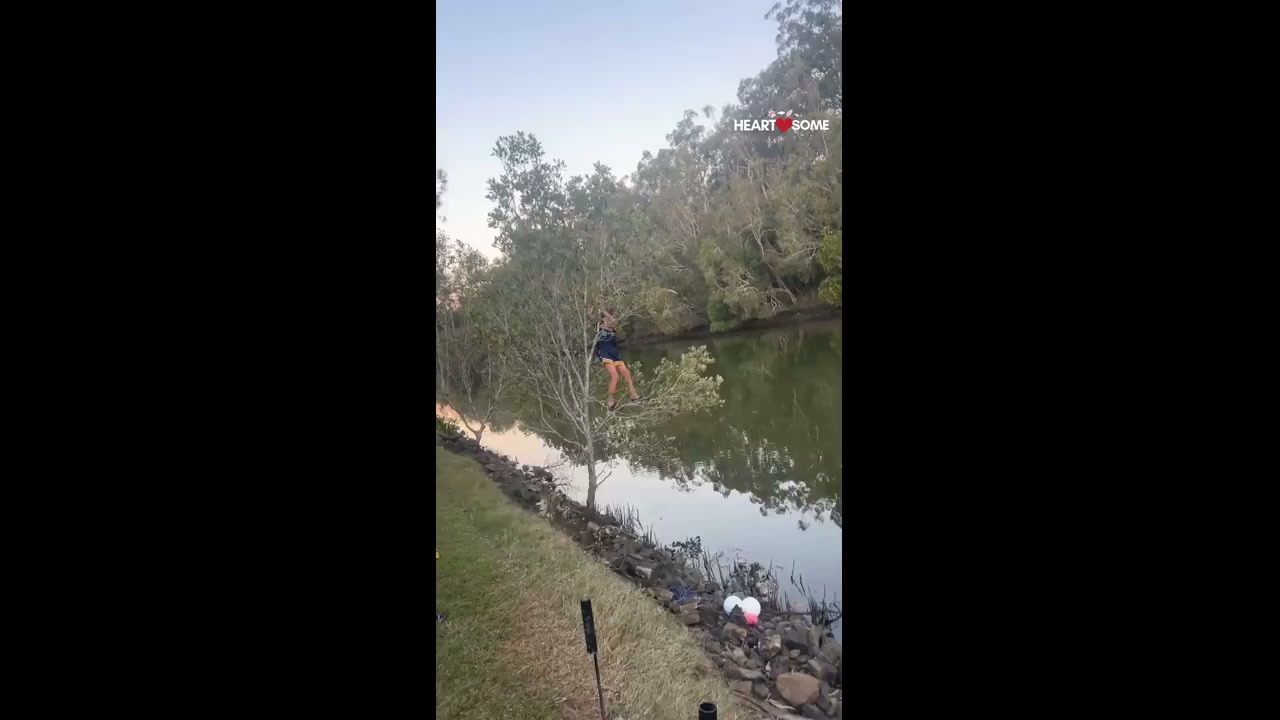 Child attempts to retrieve fishing line as tree branch gives way