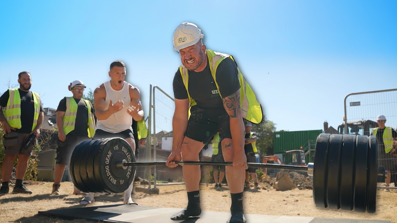 Bodybuilder struggles to lift a heavy weight before a construction ...