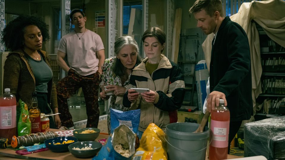 "Slow Horses" depicts ordinary London office culture — including trips to Tesco to buy potato chips and novelty caterpillar cake for a workplace party. - Jack English/Apple TV+