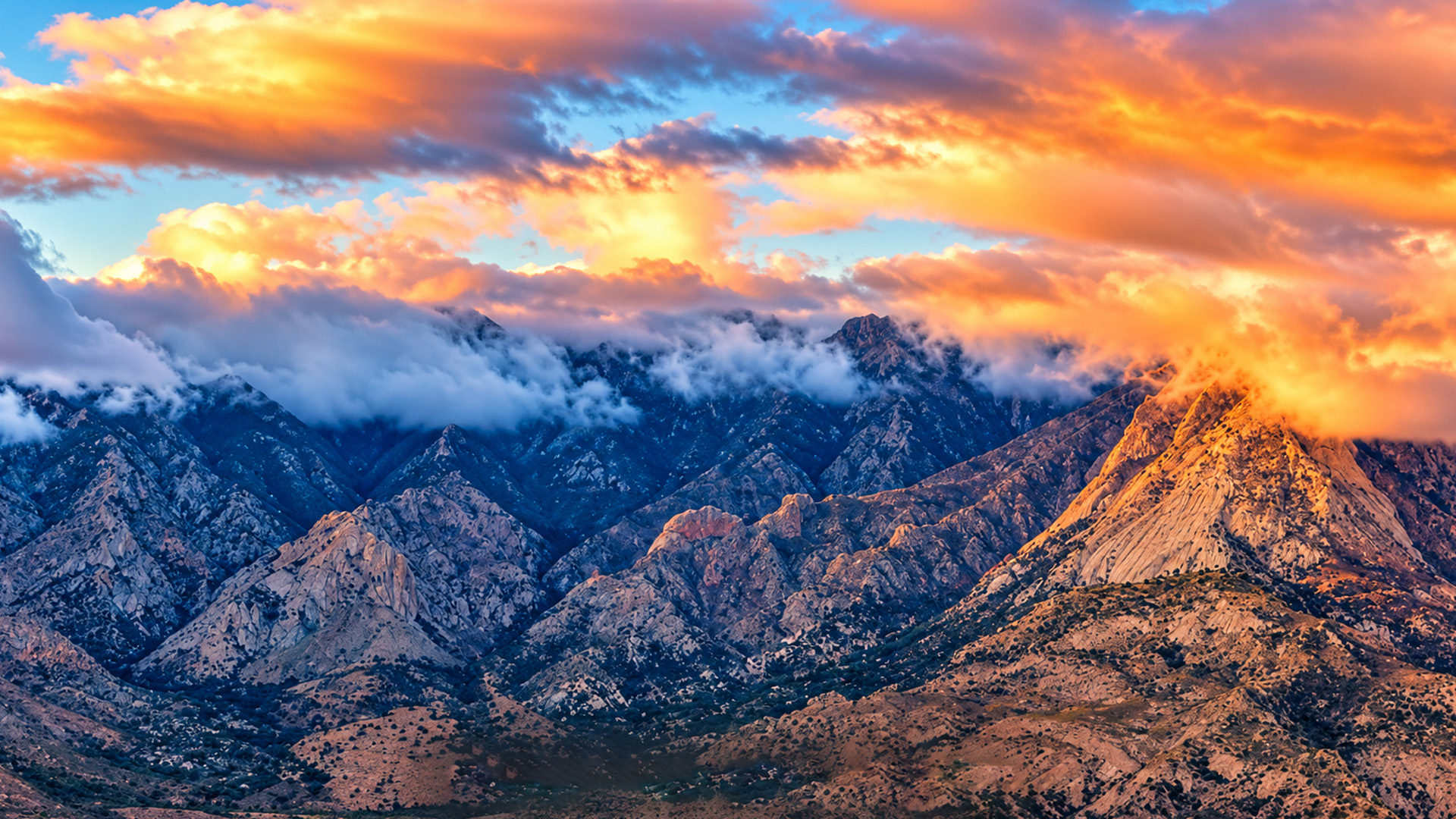 How does the sunset turn these clouds fiery orange?