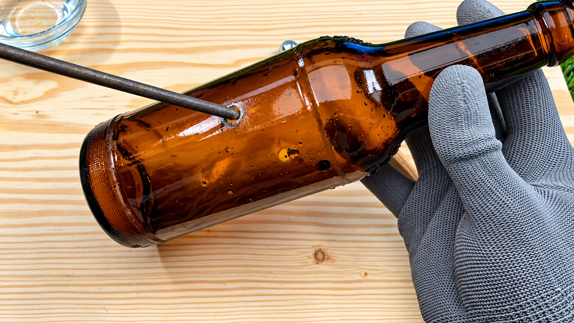 Drilling a round hole through a glass bottle without cracks