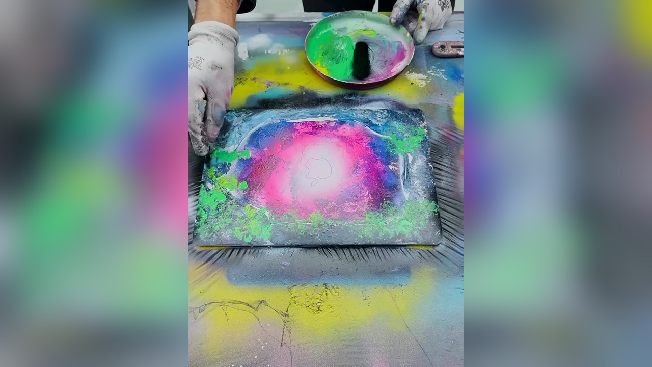 Spray painting a stranger's laptop in public