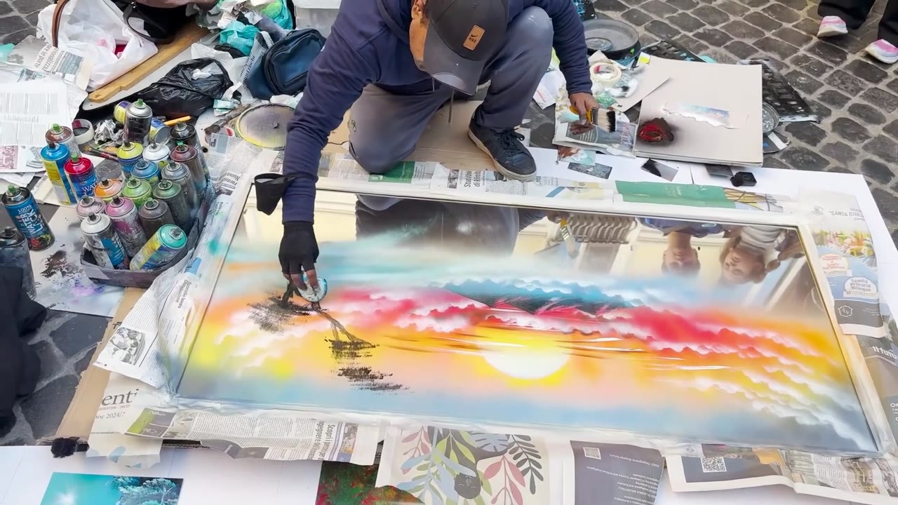 Street artist spray paints a giant mirror in Rome