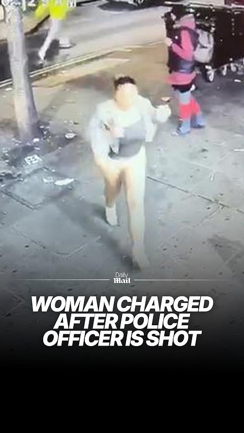 Woman is charged after police officer shot in the street