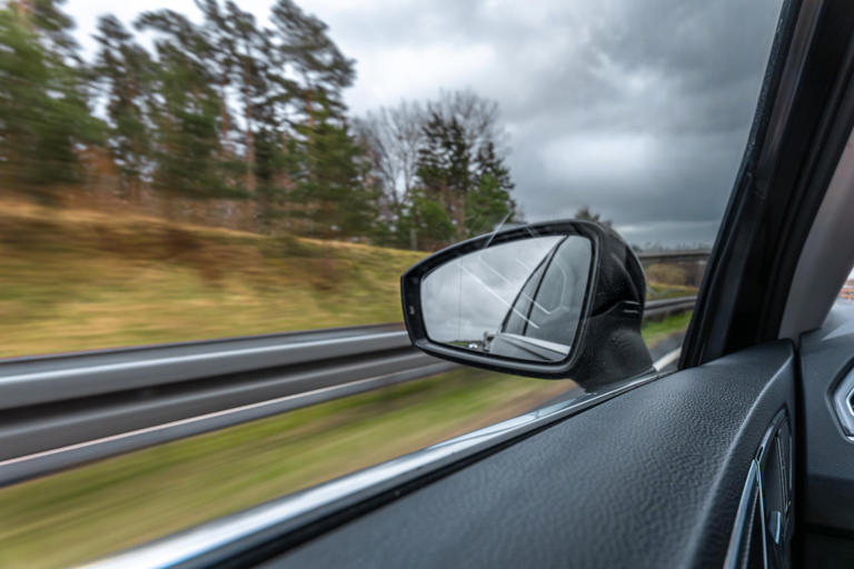 One wing mirror warns that objects are closer than they appear and the ...