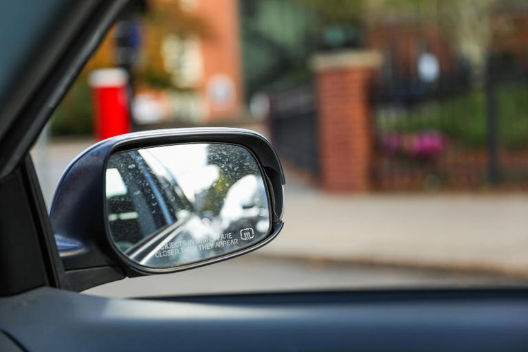 One wing mirror warns that objects are closer than they appear and the ...