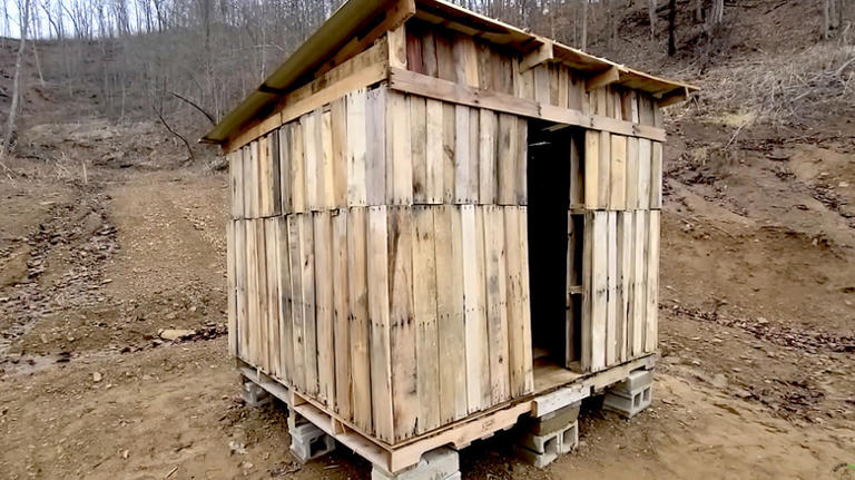 Man uses old wood pallets to build an impressive DIY chicken coop