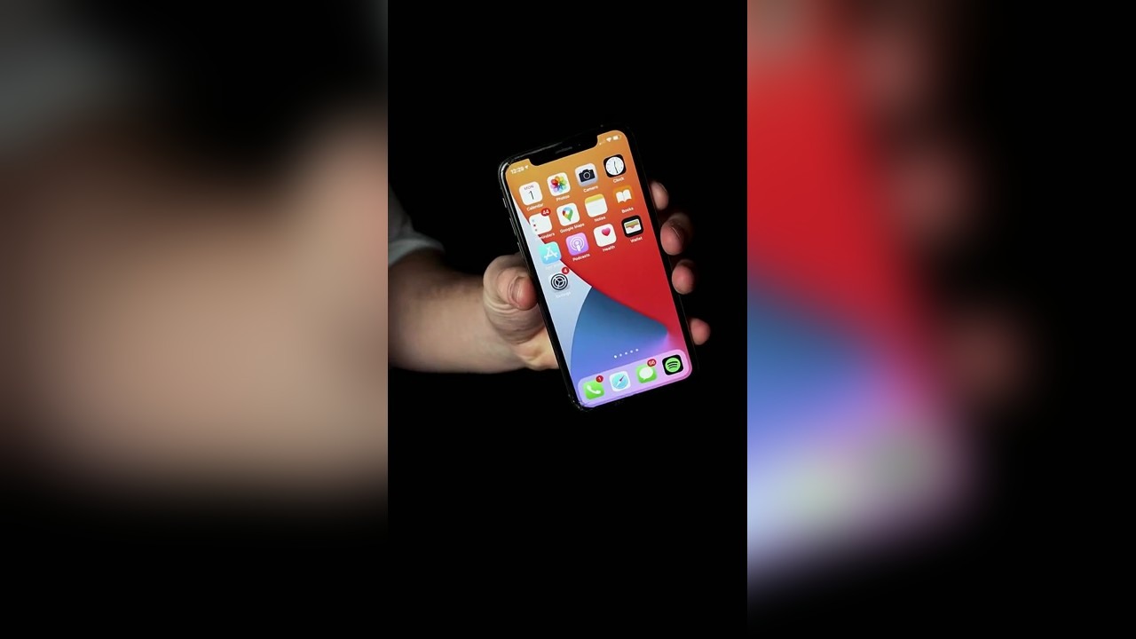 A magician makes phone apps appear to fall into his hand