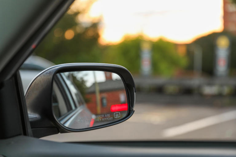 One wing mirror warns that objects are closer than they appear and the ...