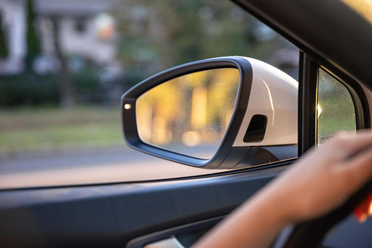 One wing mirror warns that objects are closer than they appear and the ...
