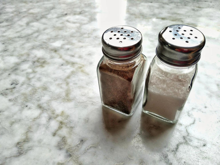 Salt and pepper shakers have different numbers of holes and almost ...