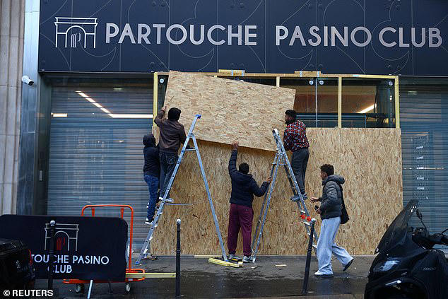 French police seize weapons and gas masks and make arrests as day of ...