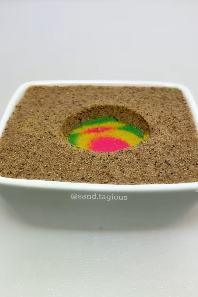 Beautiful hidden rainbow pattern inside brown sand