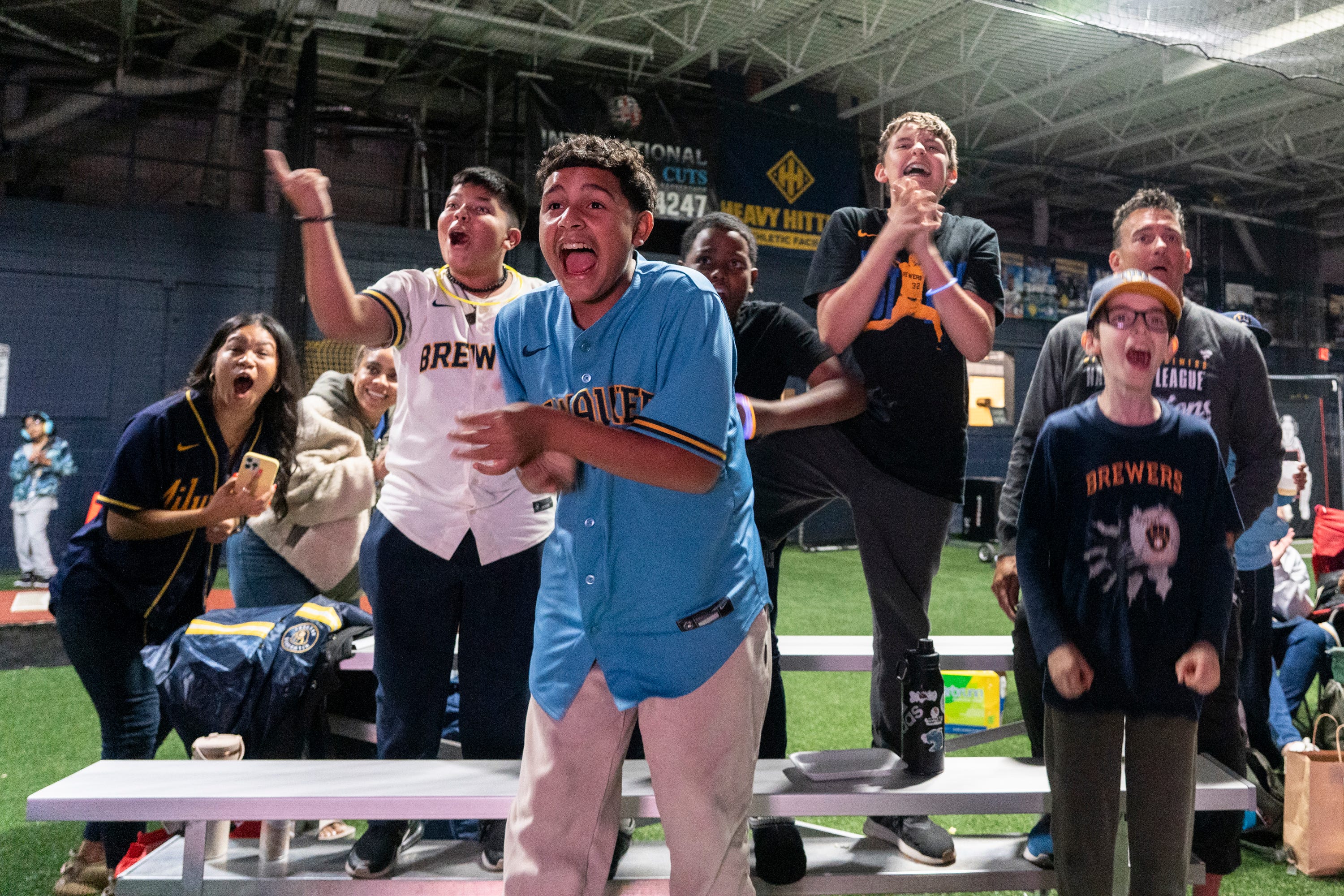 Youth baseball players cheer on Milwaukee Brewers in World Series Game 1
