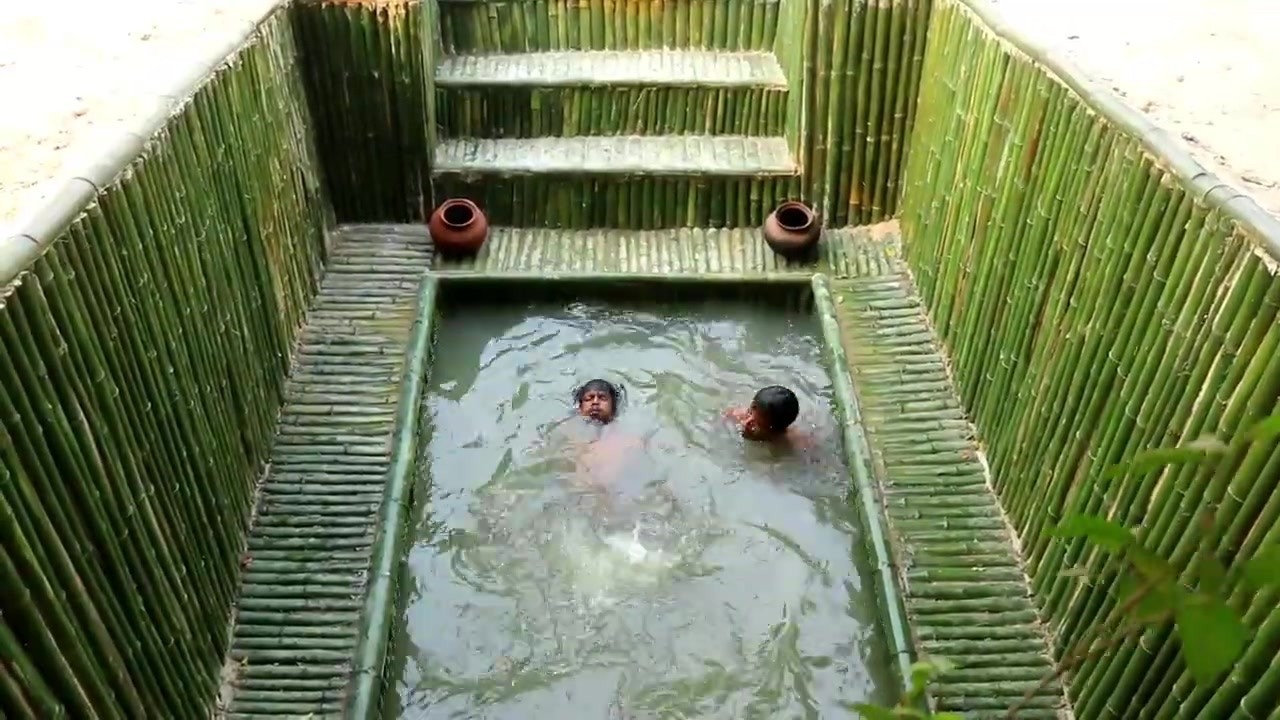 Bamboo-lined pool in front of an underground house