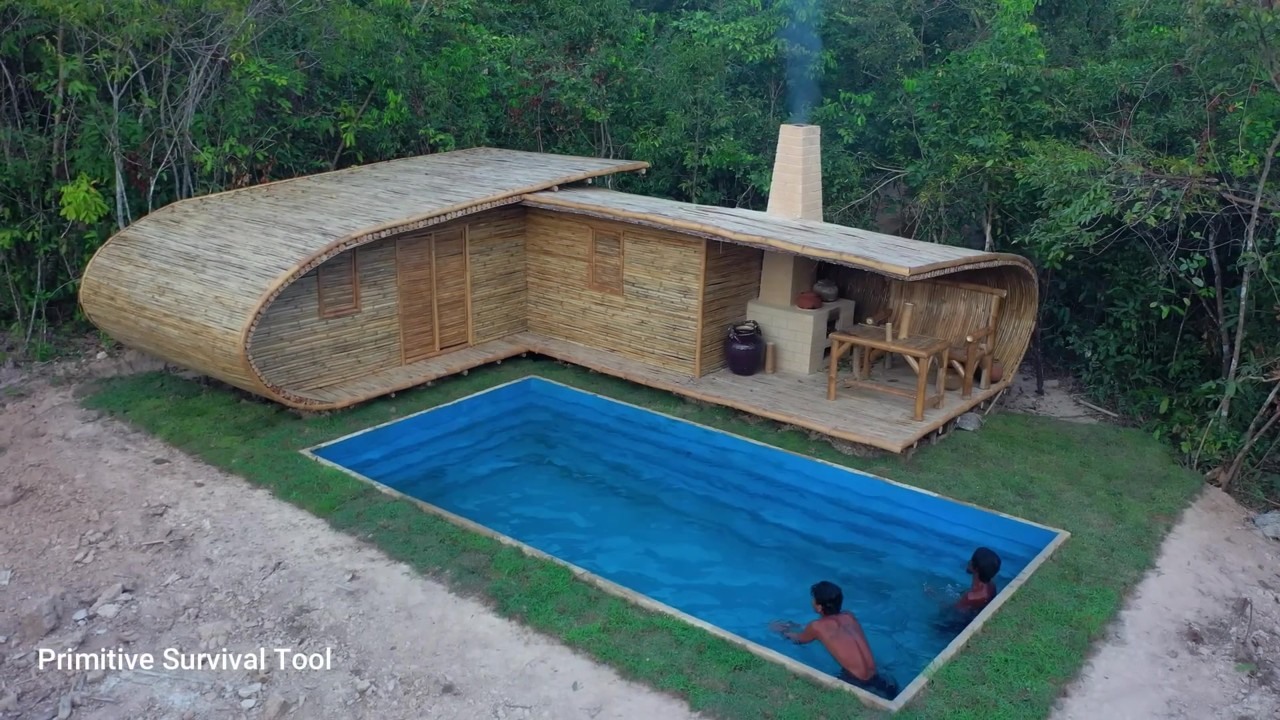 Curved bamboo jungle villa with a blue pool from above