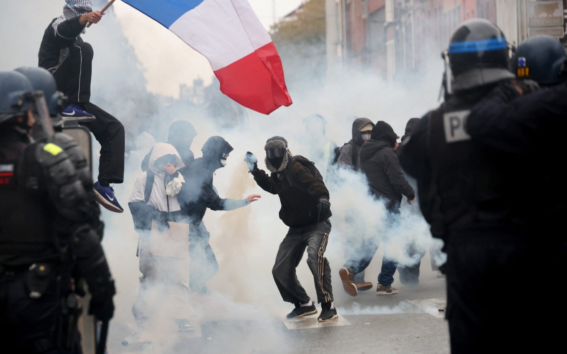 Tear gas fired and nearly 1,000 arrested as unrest erupts across France