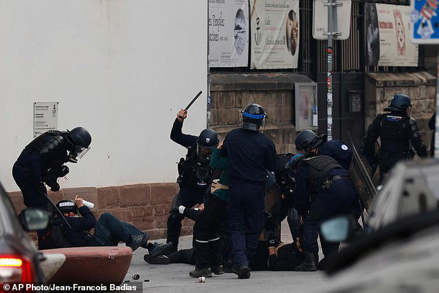 French riot police hit far-left mobs with water cannon as protests ...