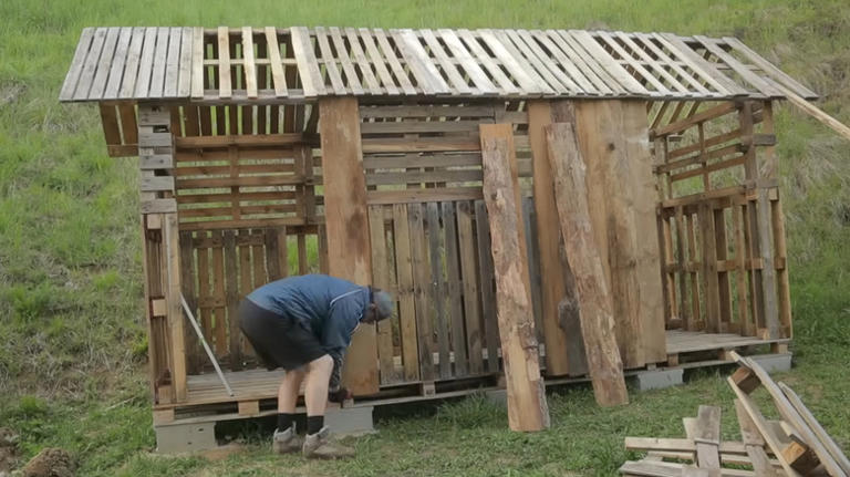Man Turns Old Wood Pallets Into A Mini Cabin With An Impressive DIY