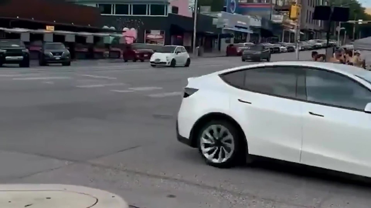 Tesla Model Y with robotaxi label seen without a driver