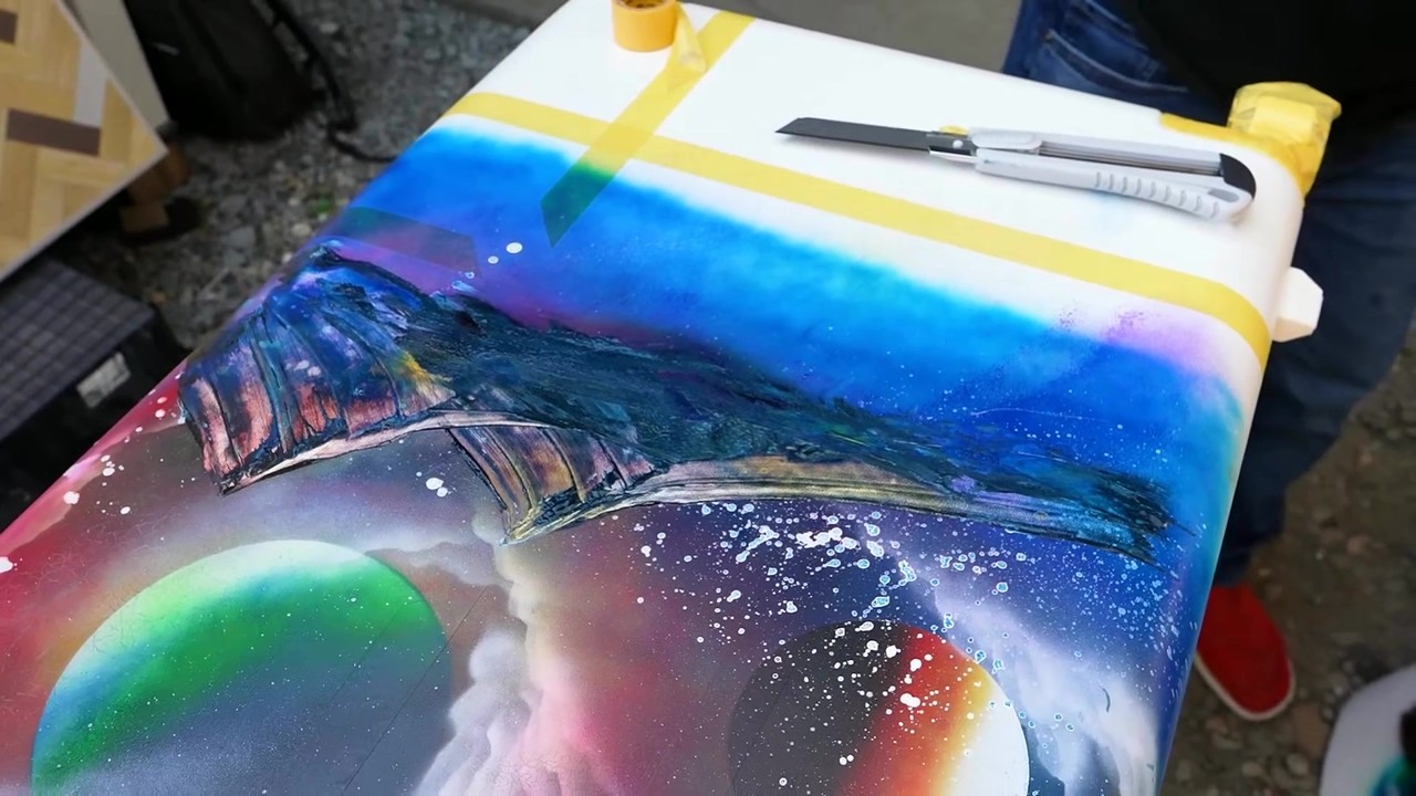 SprayArtEden spray paints a blank surface