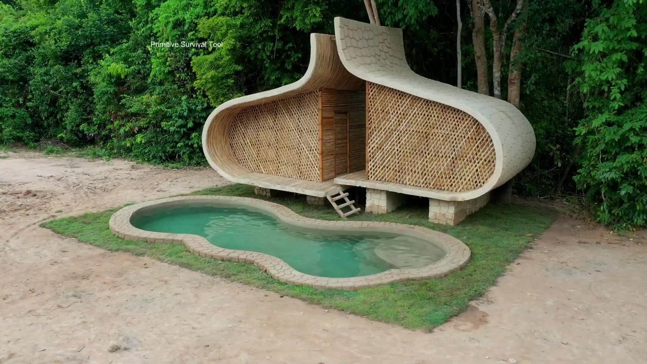 Sculptural bamboo jungle villa with a curved pool