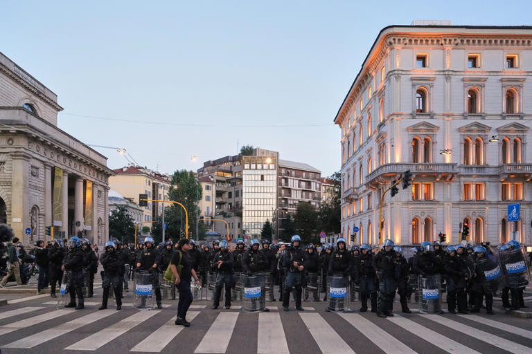 Soldiers guard center of Milan as thousands of protesters march in ...