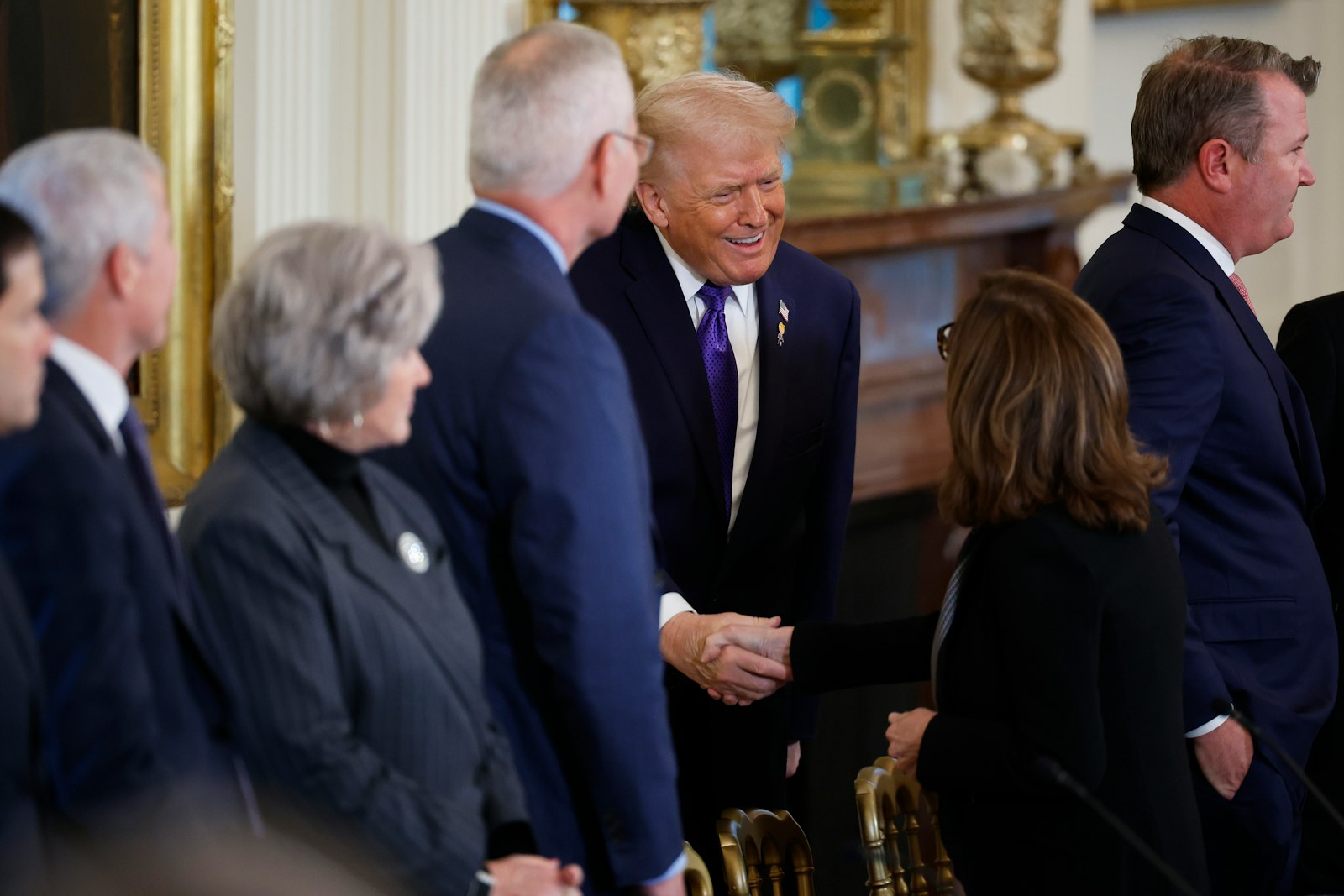 Donald Trump greets President and CEO of Marathon Petroleum Maryann Mannen as he arrives for a meeting with oil and gas executives in the East Room of the White House.