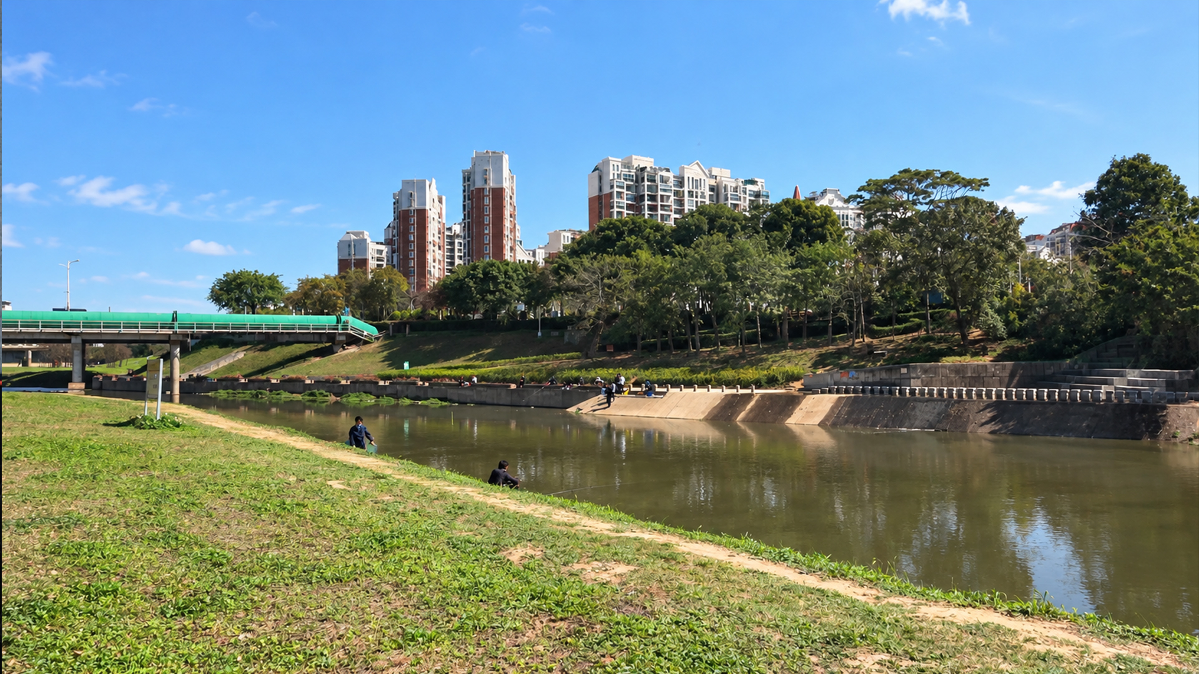 Apartment towers rise above this quiet riverside in China