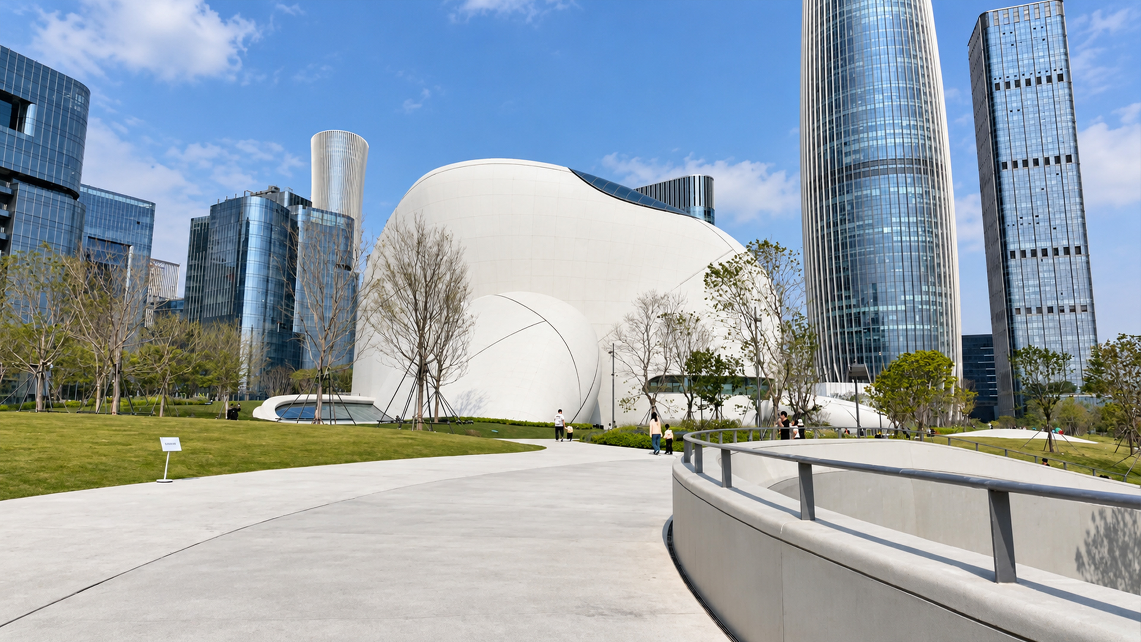 A futuristic white building sits between giant skyscrapers in Shenzhen