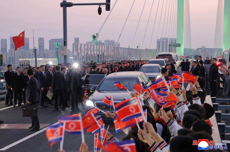 North Korean leader Kim Jong Un waves as he visits the New Yalu River Bridge linking Dandong, China, and Sinuiju, North Korea, during a trip to Dandong, Liaoning province, China, October 24, 2026, in this photo released by North Korea's Korean Central News Agency (KCNA). KCNA via REUTERS