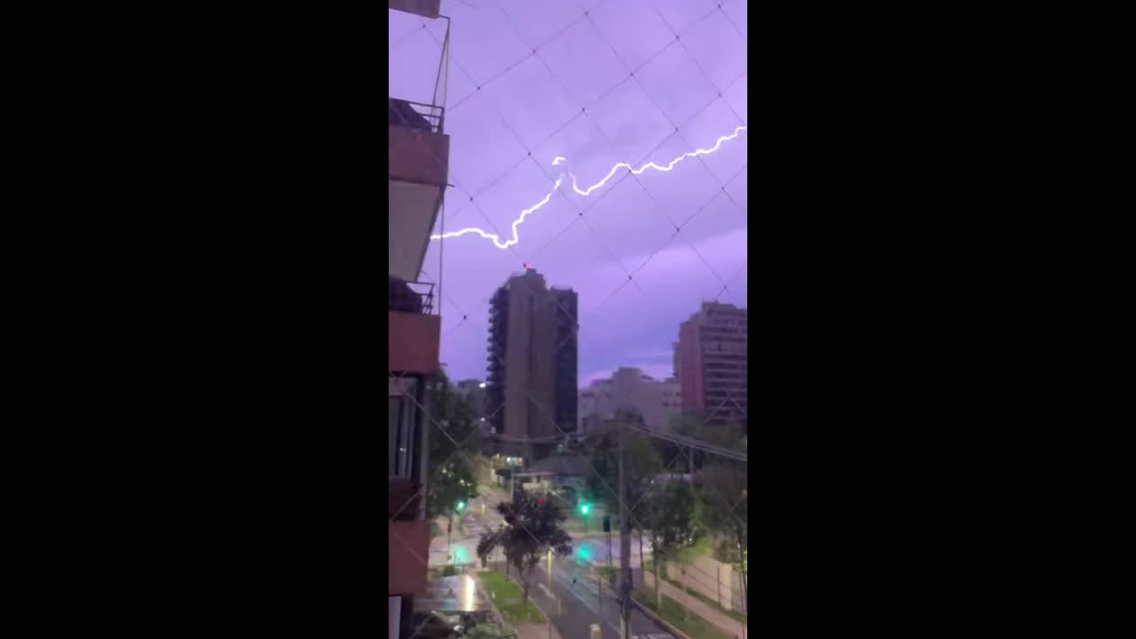 Powerful thunderstorm and lightning illuminate the sky over Las Condes ...