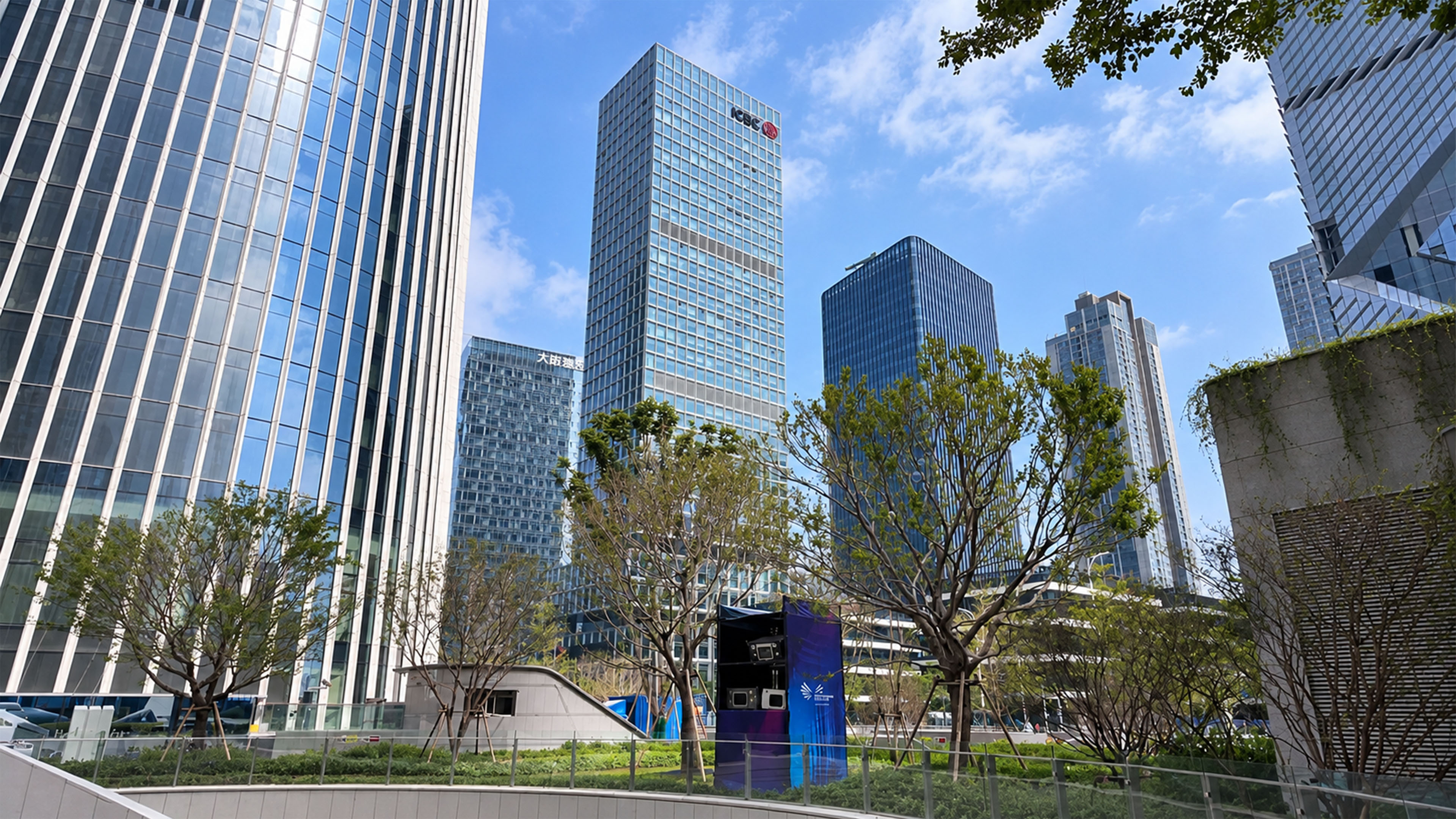 A green garden sits between giant glass skyscrapers in Shenzhen