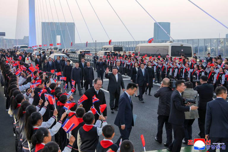 North Korean leader Kim Jong Un walks with Chinese People's Political Consultative Conference (CPPCC) Chairman Wang Huning along the New Yalu River Bridge linking Dandong, China, and Sinuiju, North Korea, during a visit to Dandong, Liaoning province, China, October 24, 2026, in this photo released by North Korea's Korean Central News Agency (KCNA). KCNA via REUTERS