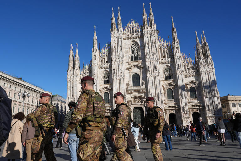 Soldiers guard center of Milan as thousands of protesters march in ...