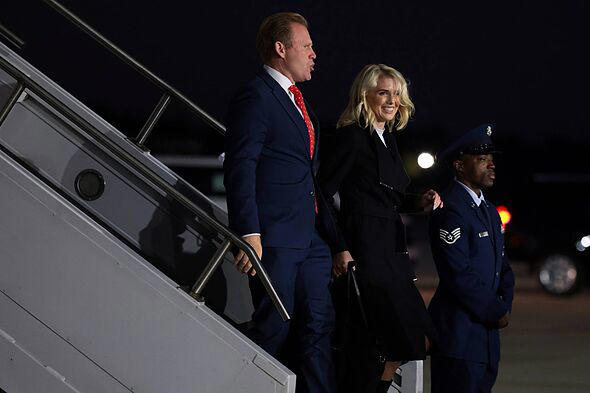 Natalie Harp beams as she boards Marine One in knee high boots