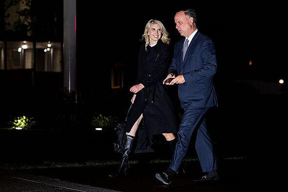 Natalie Harp beams as she boards Marine One in knee high boots