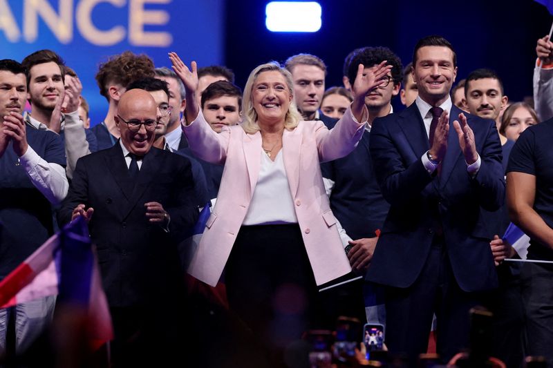 Member of parliament Eric Ciotti, president of the Union des Droites (UDR) parliamentary group and Mayor of Nice, French far-right leader Marine Le Pen, member of parliament from the French far-right Rassemblement National (National Rally - RN) party and candidate for the 2027 French presidential election, and Jordan Bardella, president of the RN party, react on stage during a political rally to launch the presidential campaign, after the party's congress in Orleans, France, October 25, 2026. REUTERS/ Stephanie Lecocq