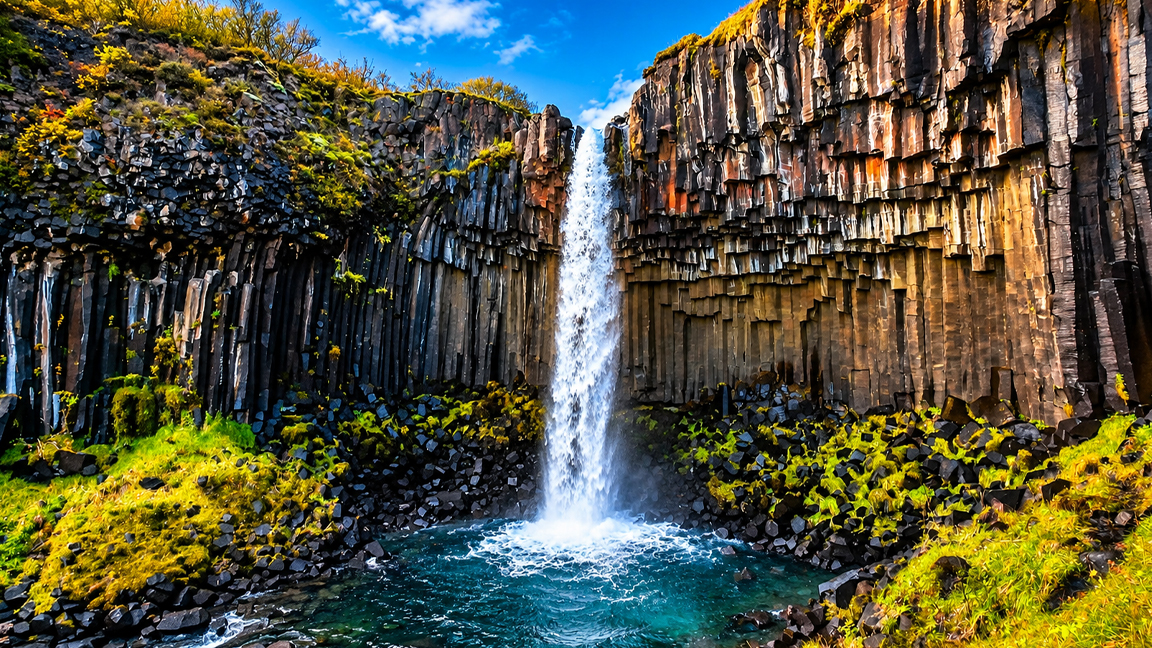 Iceland's spectacular waterfall surrounded by towering basalt columns